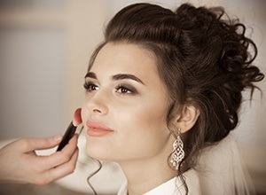 Bride being prepared with makeup and hair services