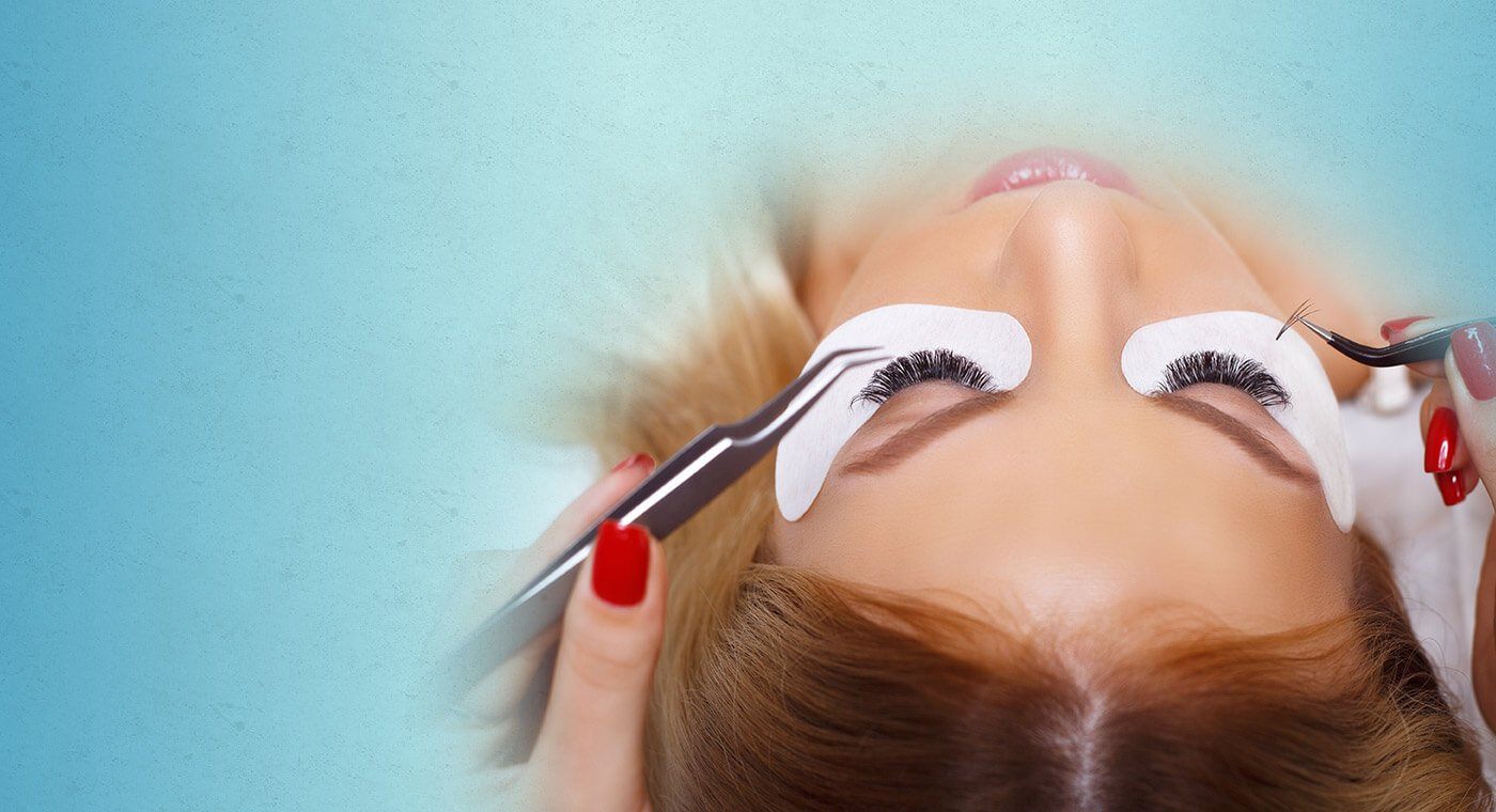 Woman receiving eyelash extensions