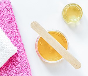 Hair removal wax and applicator