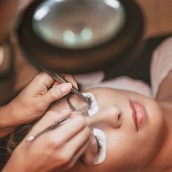 Patient receiving eyelash extensions