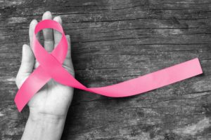 hand holding breast cancer ribbon